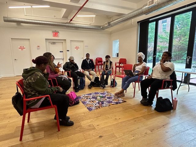 Young women seated in a circle during a Mentor Training Program session