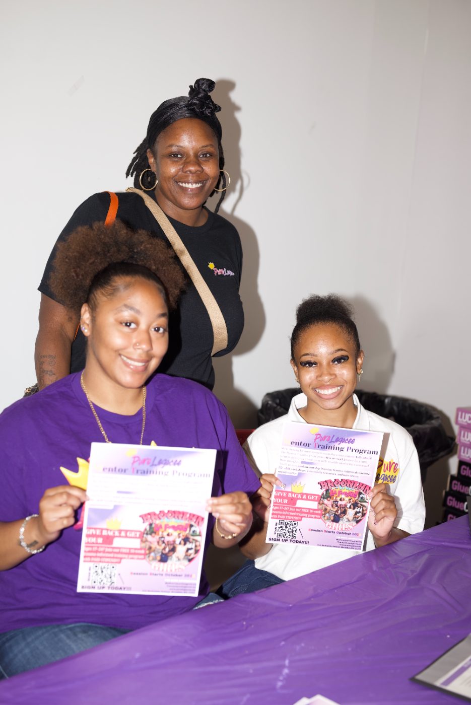 Participants smiling with flyers at Youth Fest